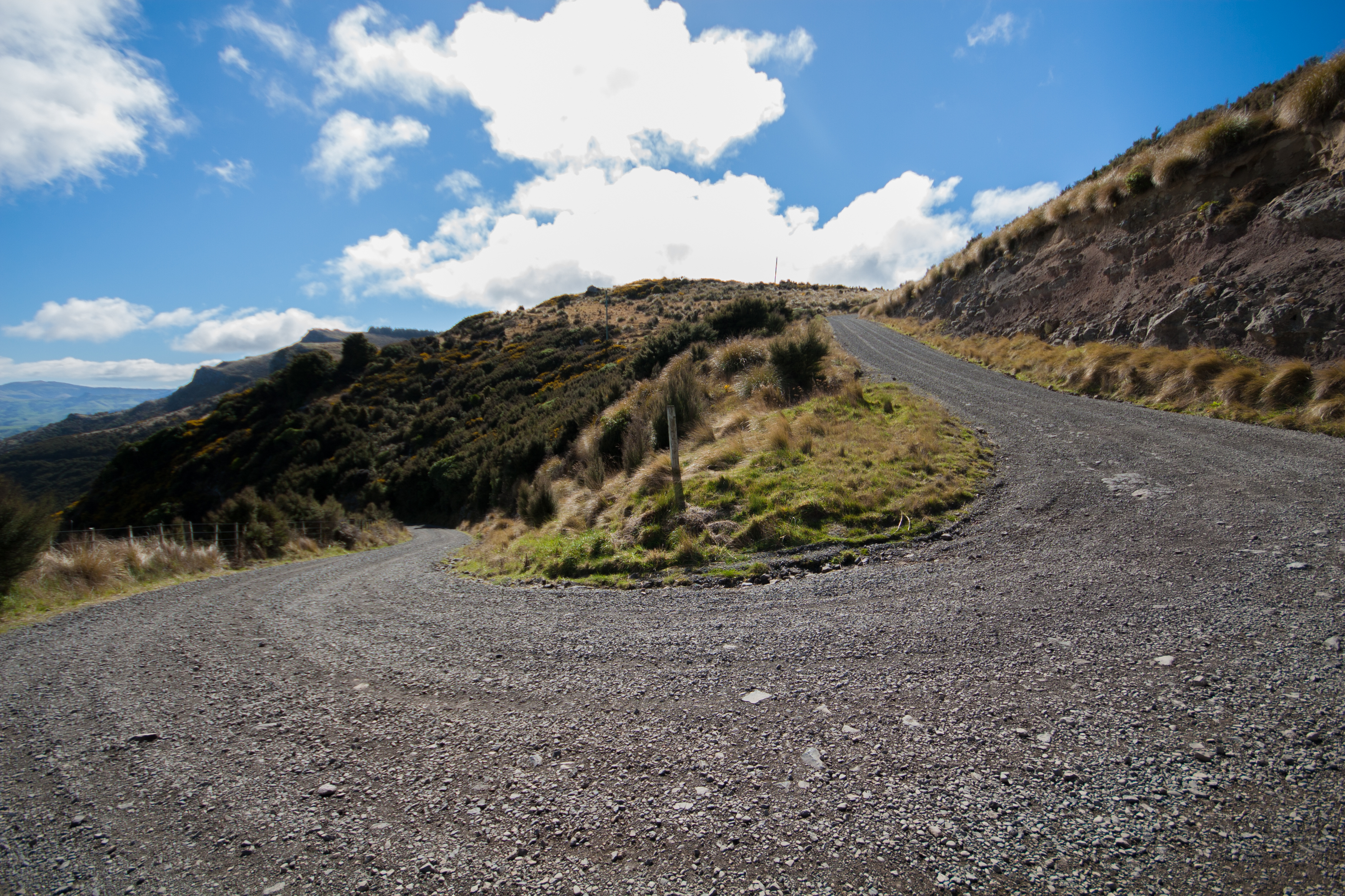 old new zealand gravel road similar to a skifield, going round a bend and up a hill