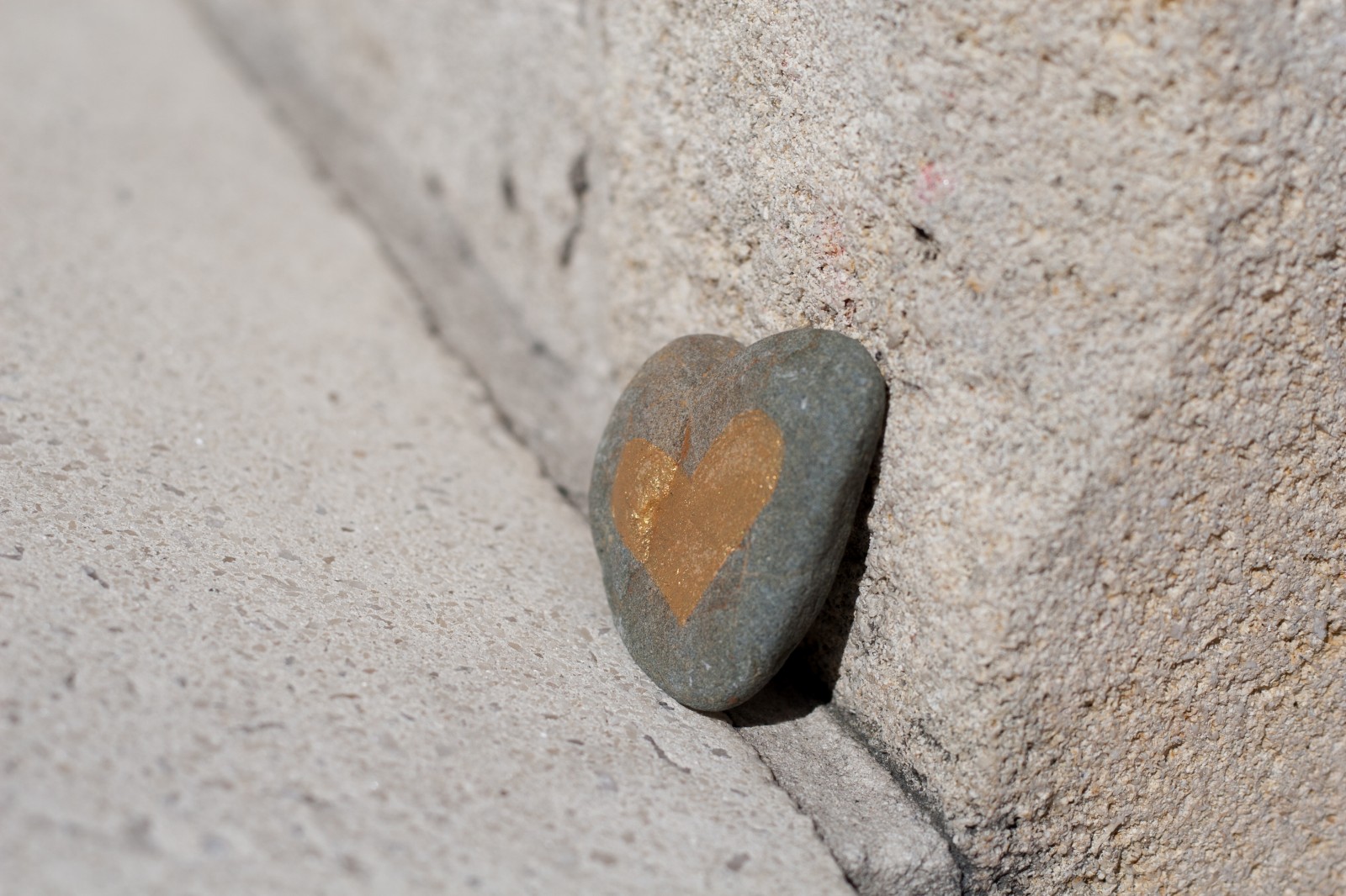 stone shaped heart with golden heart drawn on