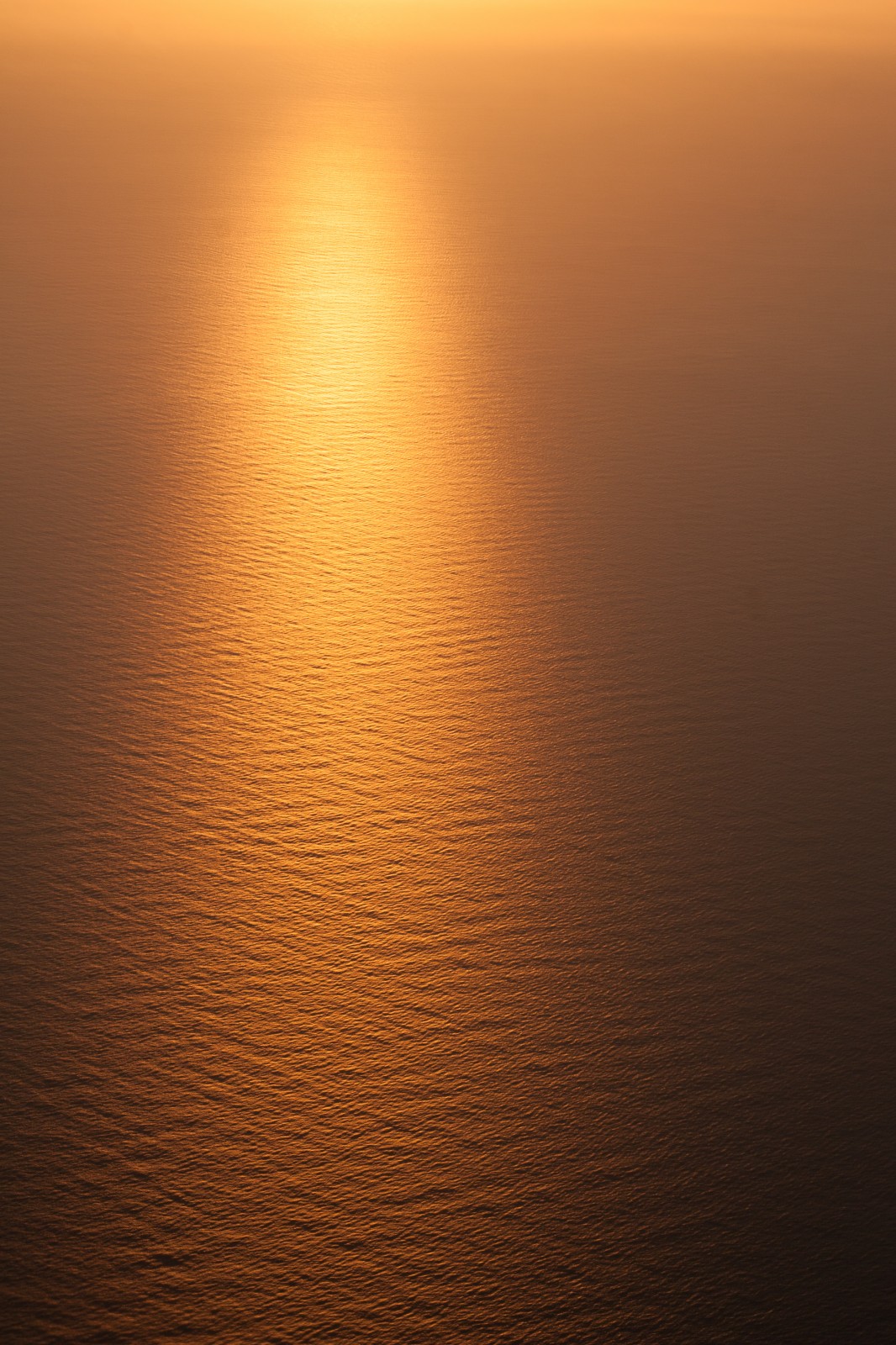 ripples in the sea from a plane at sunrise