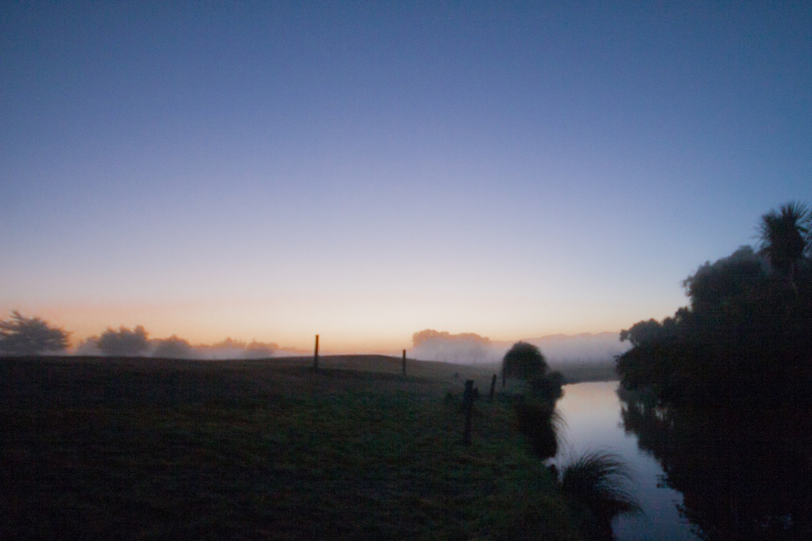 foggy morning before sunrise near river