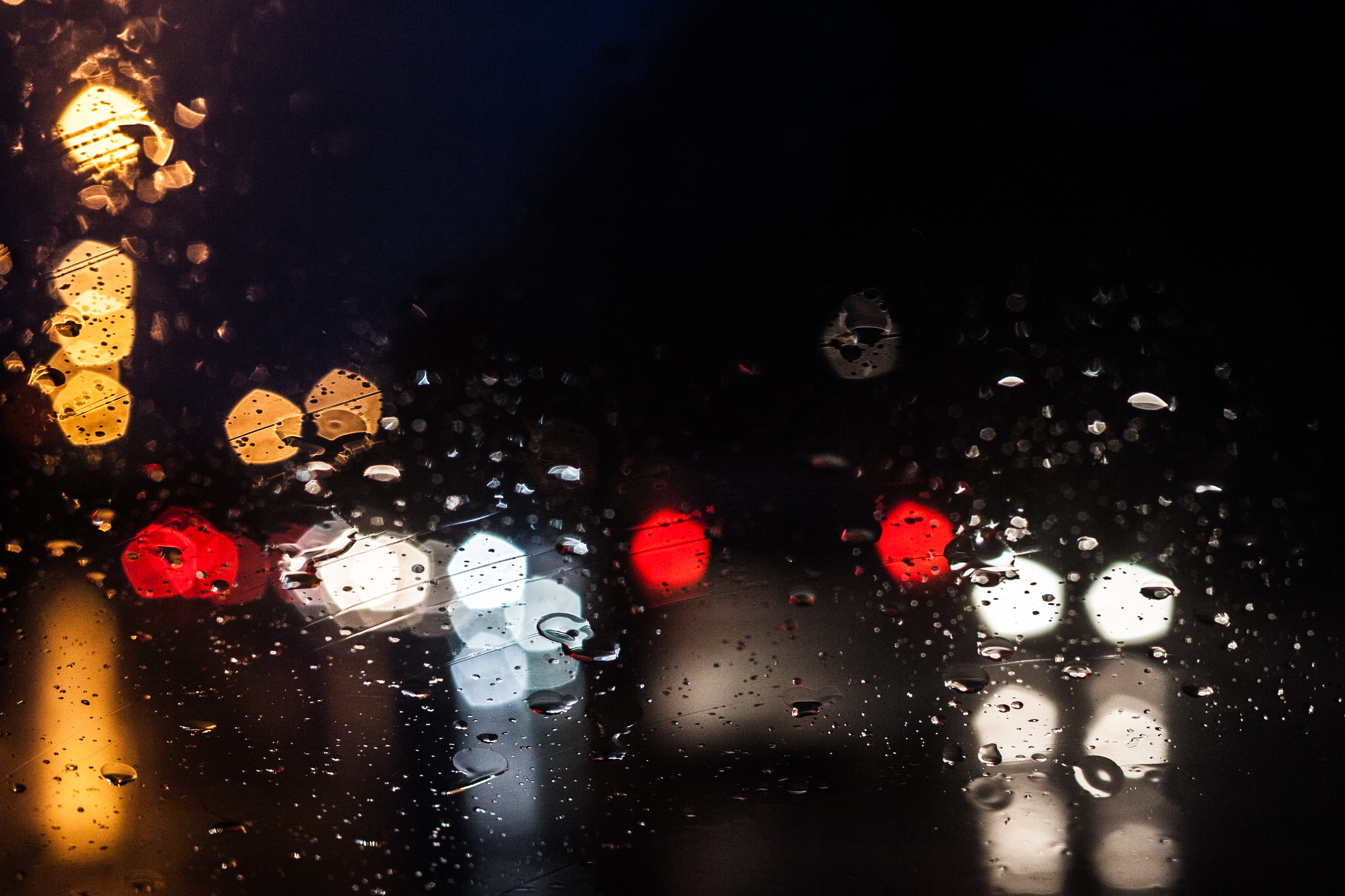 lights at night through a wet car windscreen