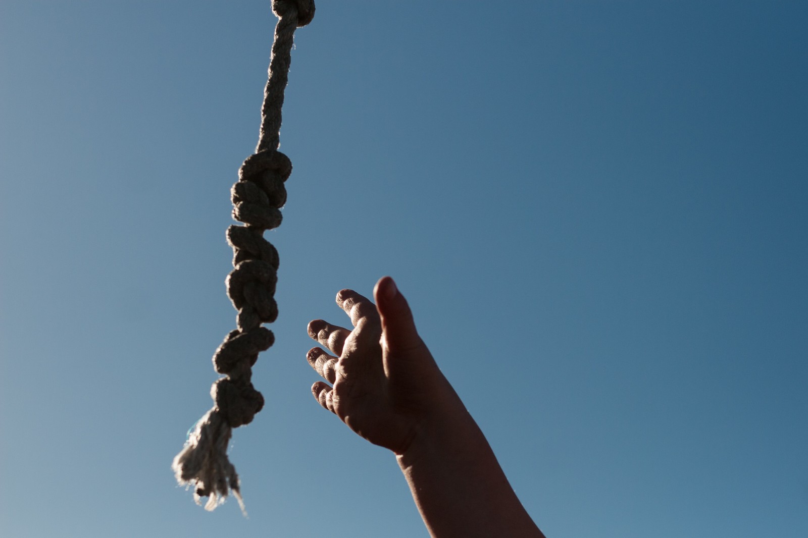 hand reaching for rope
