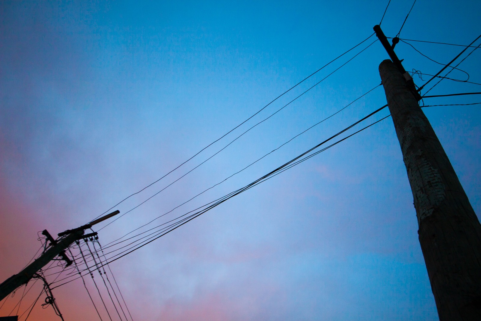 red and blue sky with power poles