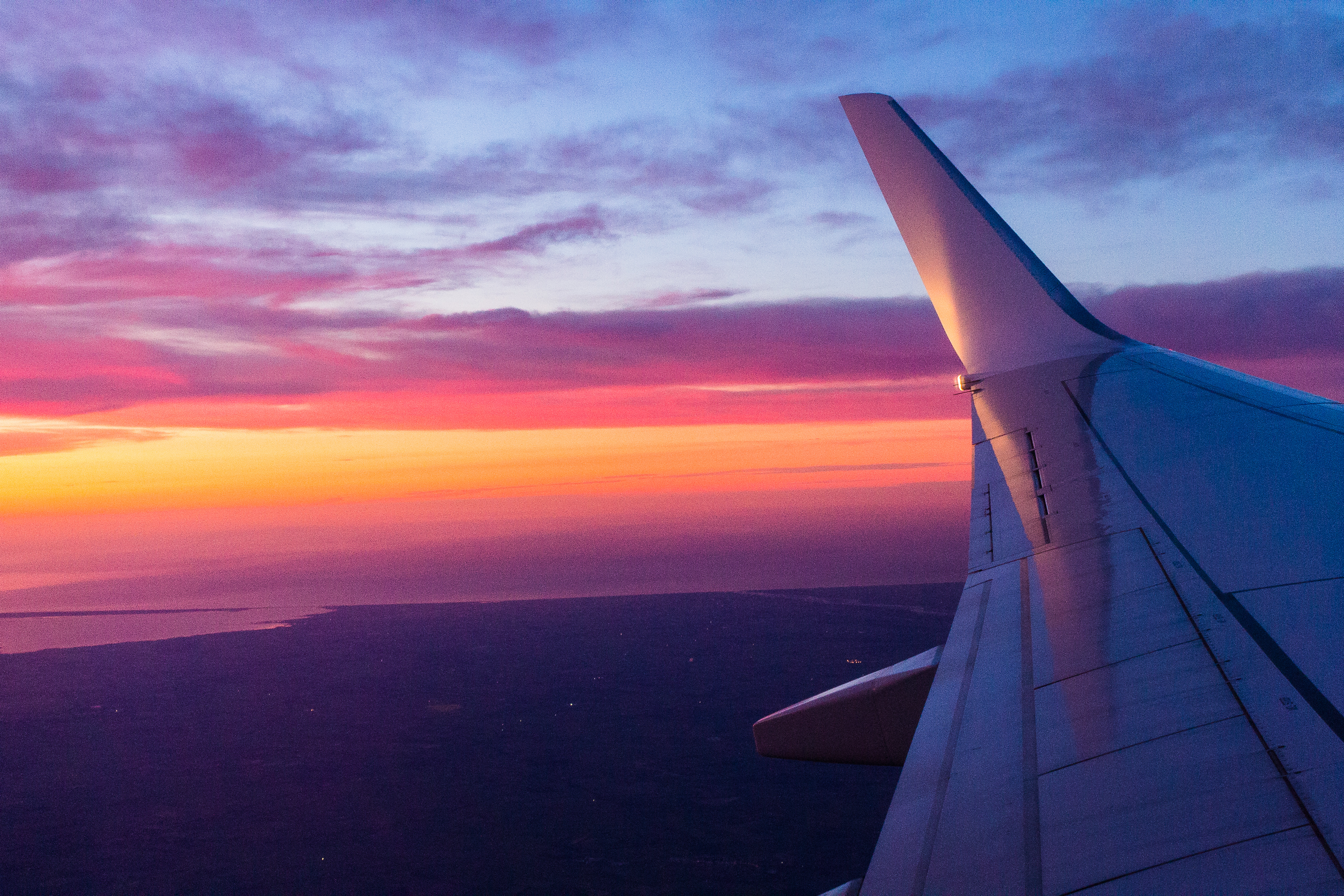 pink purple sunrise plane flight